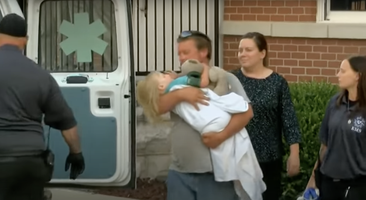 Charlee Campbell held by a man outside an ambulance, Photo Credit: Fox8 WGHP